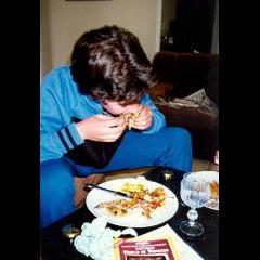 Enjoying his food in the lounge watching TV